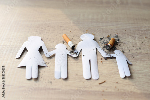 Paper cut of family destroyed by cigarettes. Quit smoking for life on World no Tobacco day concept.