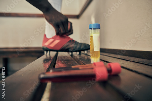 Rugby, blood and urine sample in a locker room for sports regulations or anti doping testing. Fitness, health and medical with an athlete getting ready after a drug test for an illegal substance