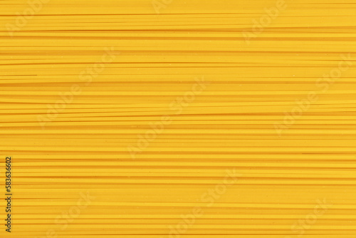 Raw spaghetti. Uncooked durum pasta. Full frame of noodles. Food background.