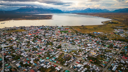 City of Puerto Natales Chile, Aerial Drone Above Town Buildings Amongst Patagonian Landscape of Idyllic Bay Water and Andean Cordillera Background