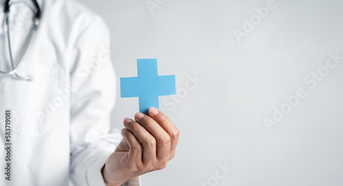 Doctor in white coat holding plus sign for assurance healthcare insurance symbol concept, Mental health care, medical check up concept.