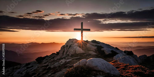 A religious cross on top of a mountain at sunset