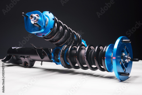 auto suspension tuning coilovers shock absorbers and springs blue for a sports drift car on a dark background