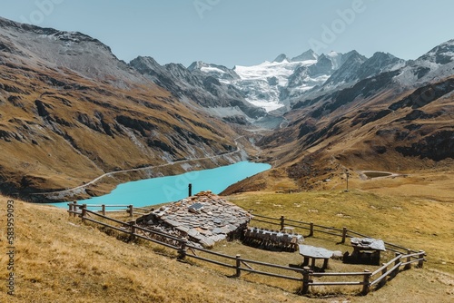 Swiss chalet in a meadow overlooking the Lake and Glacier of Moiry