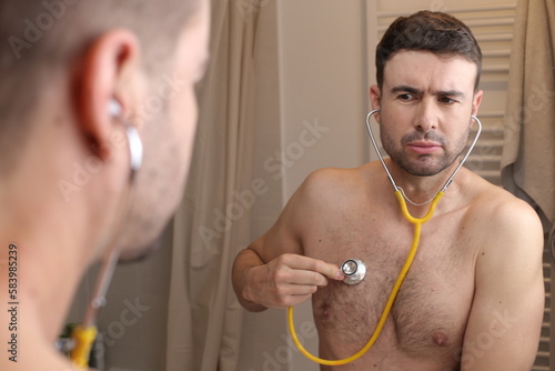 Hypochondriac man listening to his own heartbeat 