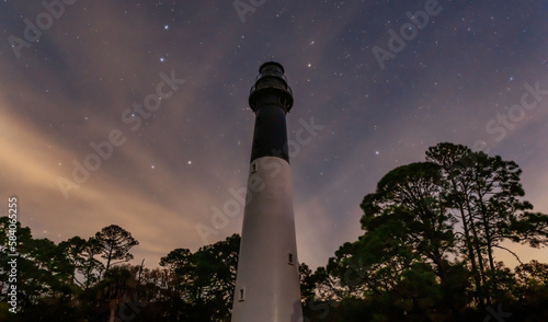 Lighthouse at night under the stars