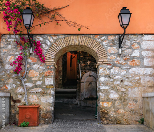 Stone arch in a terracotta wall in the Old Town of Villefranche sur Mer, France