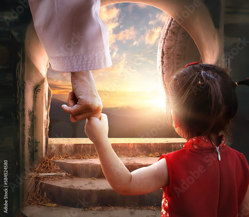 Easter and Good Friday concept, Jesus holding child's hand with empty tomb of Jesus Christ at sunset background