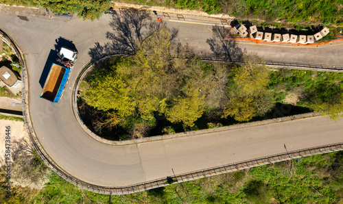 Perpendicular aerial view on a truck turning into a hairpin bend.