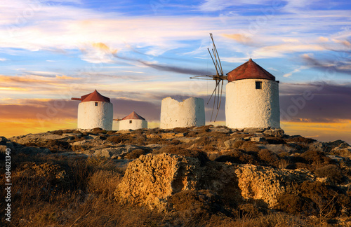 Traditional typical greek windmills. Amorgos island in Cyclades, Chora village over sunset