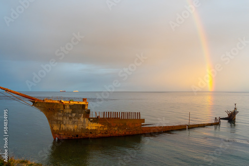 Lord Lonsdale shipwreck with rainbow at dusk in the coast of Punta Arenas, Chile. The Lord Lonsdale started its final journey in Hamburg, Germany in 1909, why it ended up here is a mystery.