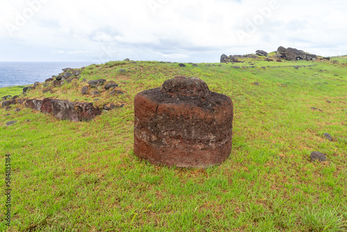 A Pukao with petroglyphs in Vinapu on Easter Island (Rapa Nui), Chile -2023. The pukao is an ornament, made of red scoria from the crater of Puna Pau which was placed on the head of the statues. 