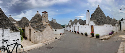 street borded by famous houses the trulli with a conical roof in southern Italy in Puglia in Alberobello village