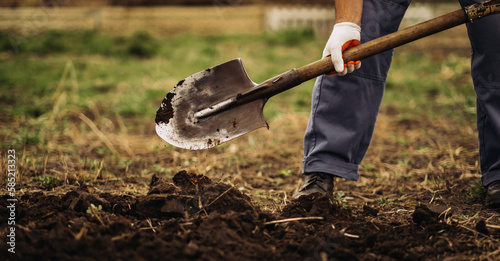 The gardener digs the garden with a shovel