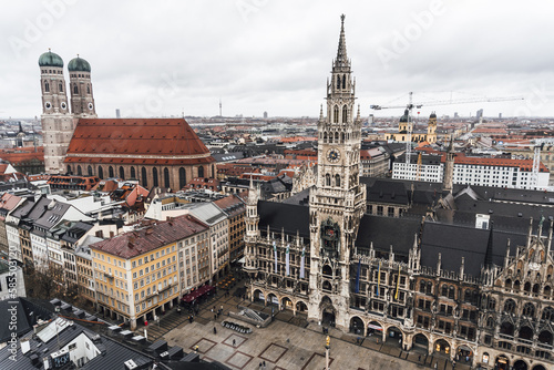View from the bell tower of the church of saint Peter of the city of Munich, where you can see the cathedral and the town hall, on a cloudy and rainy day.