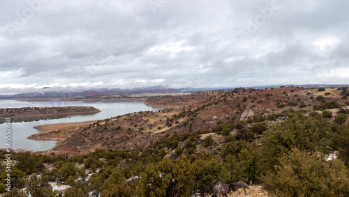 Water reservoir in red rock basin with overcast skie in rural New Mexico