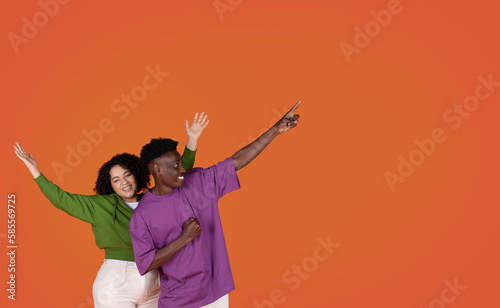 Emotional black man and hispanic woman couple showing copy space