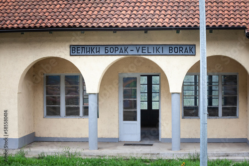 entrance to the train station of Veliki Borak, with the name of the village Veliki borak written in latin and cyrillic alphabet. it's a rural train station in the serbian countryside, in the area of K