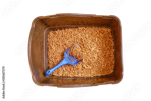 Brown toilet tray for cat with wood pellets and scoop, isolated on a white background. The cats toilet clean is filled with granules of wood. Wooden filler for animals litter
