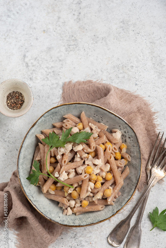 Spelt penne pasta with chicken and chickpeas. Healthy lunch or dinner meal