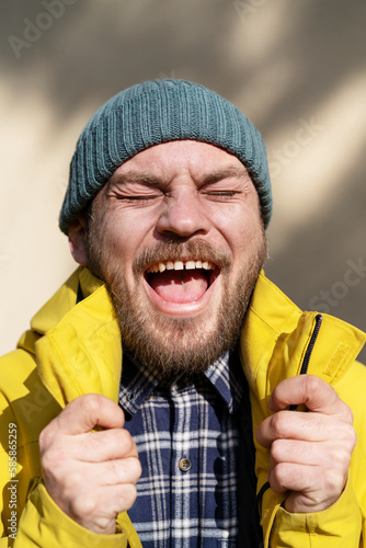 Candid positive emotions of adult bearded man.