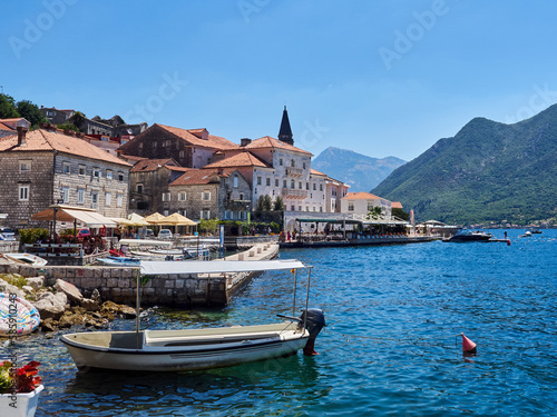 View of the touristic village of Perast, with boats in the harbour, a baroque palace and the tower of the church. Vacations in the Adriatic sea, Montenegro, Europe