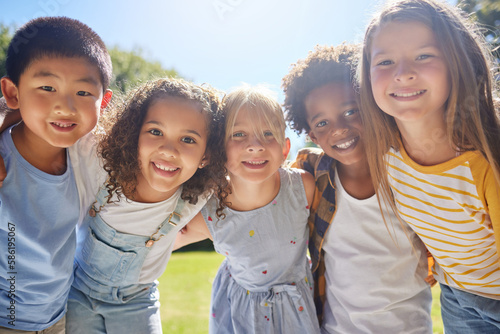 Happy, smile and portrait of kids in a park playing together outdoor in nature with friendship. Happiness, diversity and children friends standing, embracing and bonding in a outside green garden.