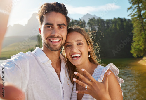 Couple, portrait selfie and engagement by lake for celebration, happiness and excited for future. Man, woman and photography for social media, profile picture and romance for love, proposal and goals