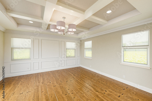 Beautiful Tan Custom Master Bedroom Complete with Entire Wainscoting Wall, Fresh Paint, Crown and Base Molding, Hard Wood Floors and Coffered Ceiling