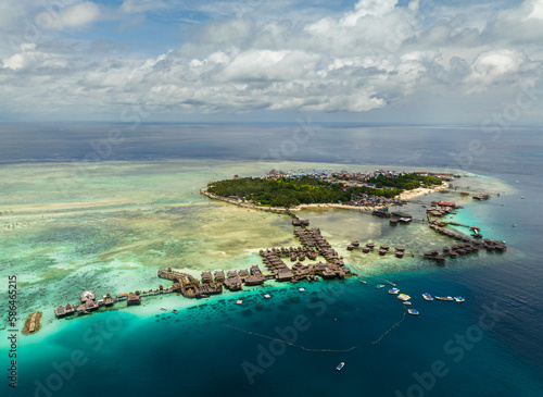 Aerial view of tropical island of Mabul with a beautiful beach and coral reef. Semporna, Sabah, Malaysia.