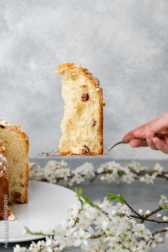 Hand holding piece of Easter cake on dessert spatula