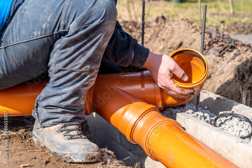 installation of a sewage plastic pipe during the construction of a house