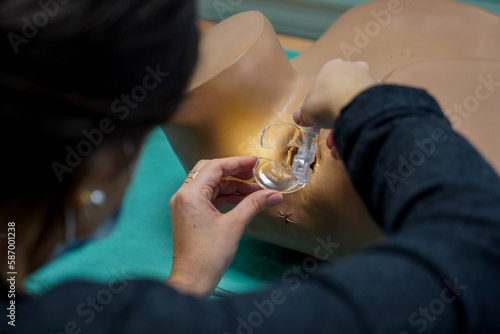 5th year student of medicine during a course in Gynecology at the medical university of Nimes. Placement of a speculum and vaginal smear.