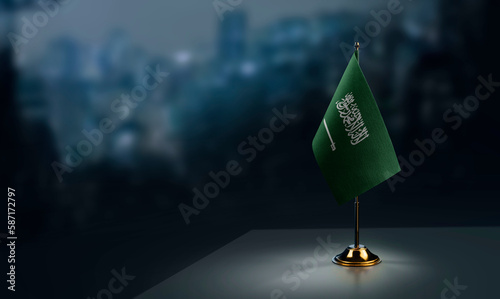 Small flags of the Saudi Arabia on an abstract blurry background