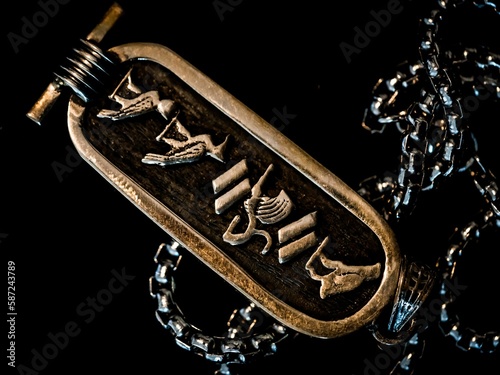 Closeup shot of the Egyptian Cartouche amulet on a black background