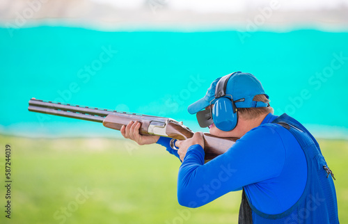 Clay pigeon shooting. An athlete shoots a gun at moving targets, sport gun shooting, clay pigeon shooting. Training process at the shooting range.