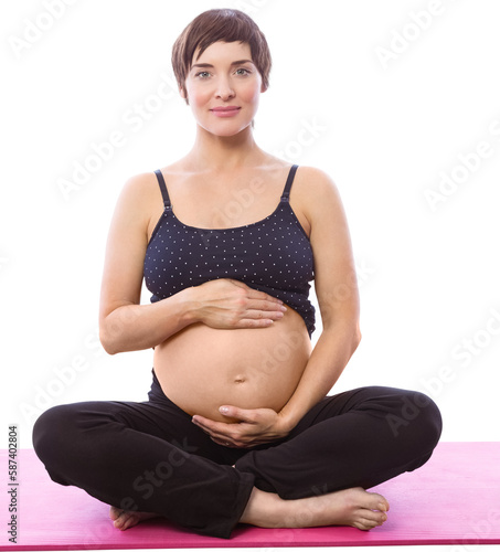 Portrait of happy expecting woman sitting on exercise mat