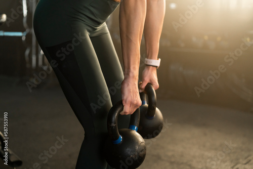 Fitness woman exercising with kettlebell at the gym