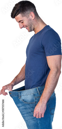 Man smiling while stretching jeans