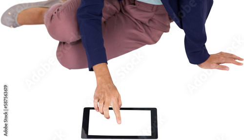 Low section of businesswoman using digital tablet over white background