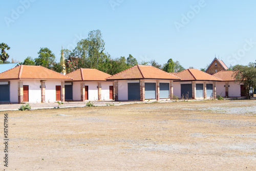 Row of small houses or booth in bright sunlight beside dry grass. Souvenir shop of abandoned tourist attractions. by government to support tourist attractions wasting the national budget at Thailand.