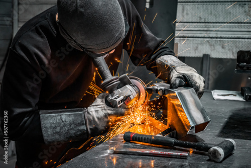 worker grinding a piece of metal