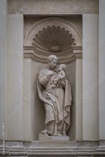 Lviv, Ukraine - March, 2023: Figure of Jesuit saint Stanislaus Kostka carved of sandstone by Feliks Pawliński, was placed in the lower tier niches of the Saints Peter and Paul Garrison Church.