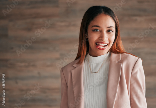 Happy, portrait and woman with her tongue out by a wall with a positive, goofy and confident mindset. Happiness, excited and headshot of a young female model fro Mexico with a silly face expression.