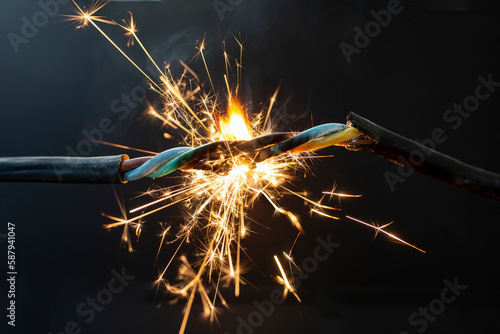 flame smoke and sparks on an electrical cable, fire hazard concept