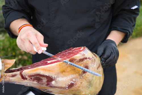 Detail of an Iberian ham cut by a professional. Concept pork, food, ham, iberian, spain, denomination of origin.