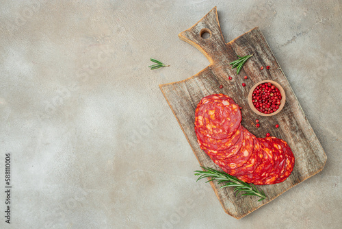 Spanish traditional chorizo sausage on a wooden board. banner, menu, recipe place for text, top view