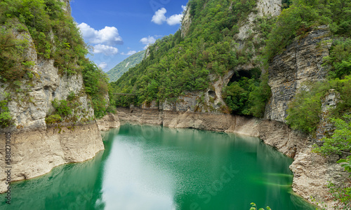 Beautiful landscape of Lake Corlo in Italy surrounded by rocks.