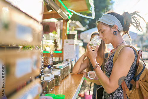 two female tourists shopping for marijuana at legal cannabis shop in pattaya thailand and smelling product