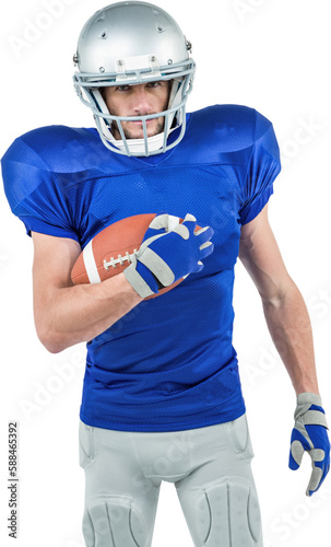 Portrait of confident American football player holding ball